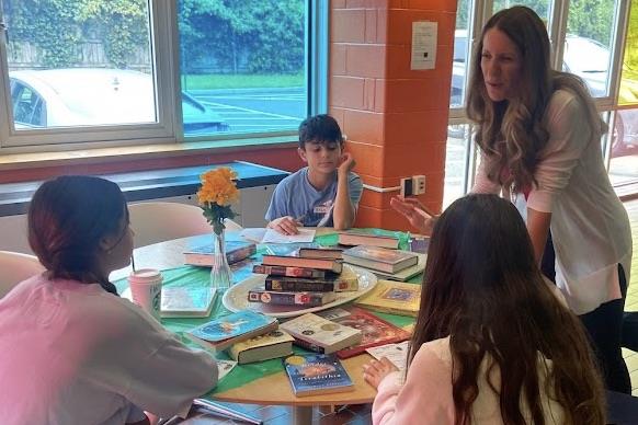 kids at table with books